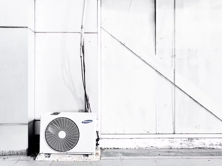Ageing outdoor AC unit nearing the end of its service life in Texas heat
